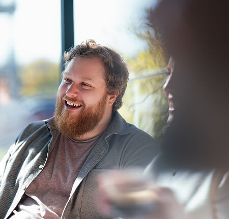 Photo of a man smiling away from camera