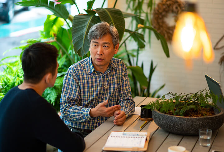 Photo of two men in discussion